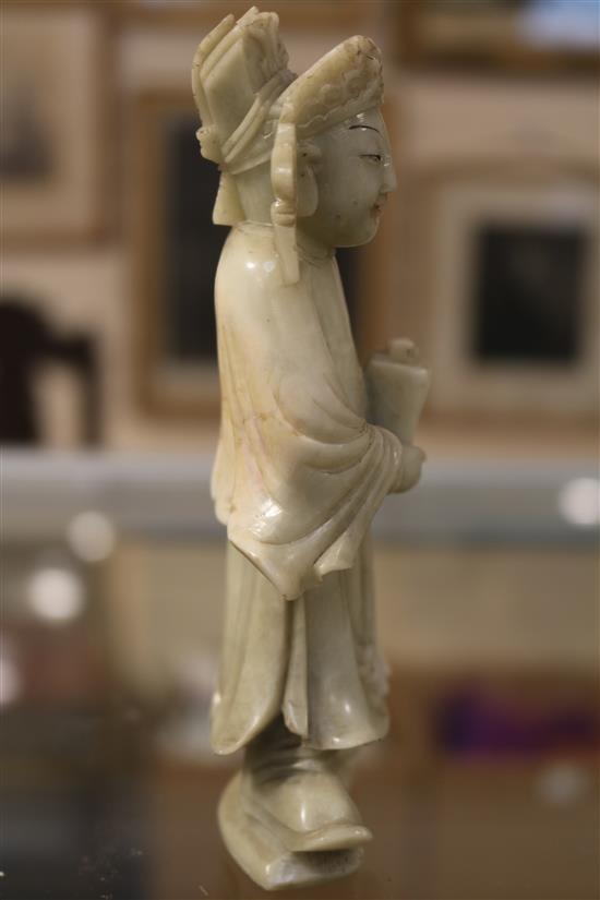 A Chinese soapstone carving of a man holding a jardiniere & other carvings